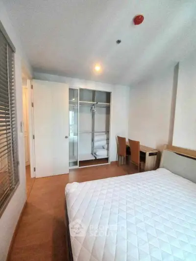 Spacious bedroom with modern closet and cozy seating area