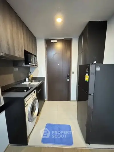 Modern compact kitchen with sleek appliances and stylish cabinetry