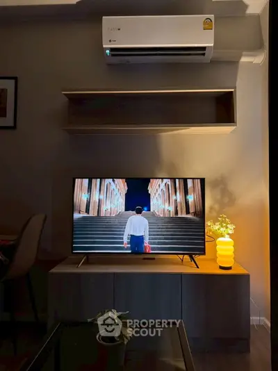 Modern living room with stylish TV setup and air conditioning unit