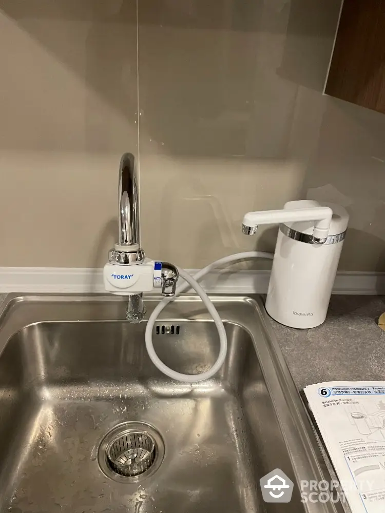 Modern kitchen sink with water filter and dispenser in stylish apartment