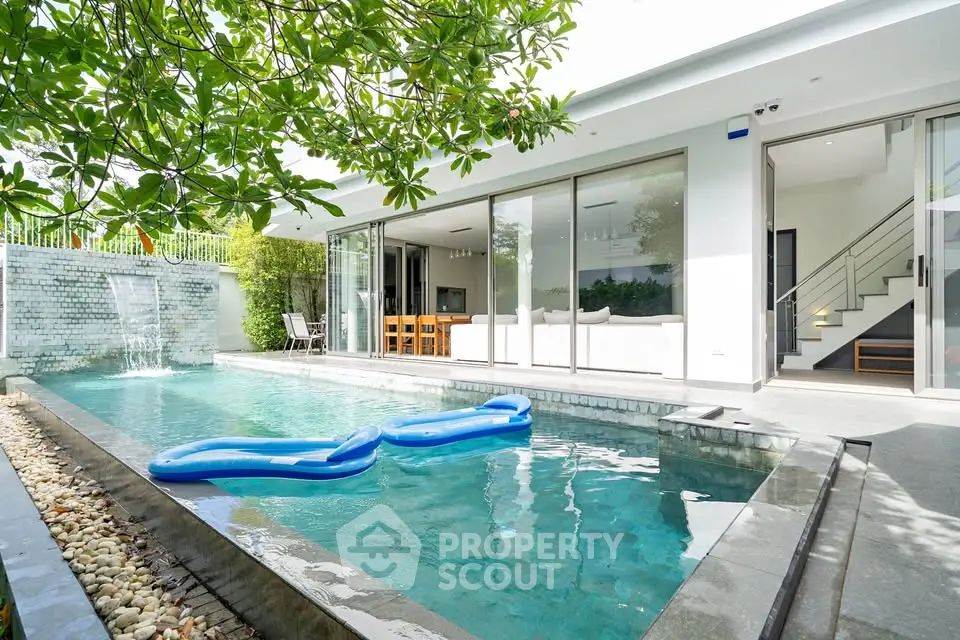 Luxurious modern villa with private pool and lush greenery, perfect for relaxation and entertainment.