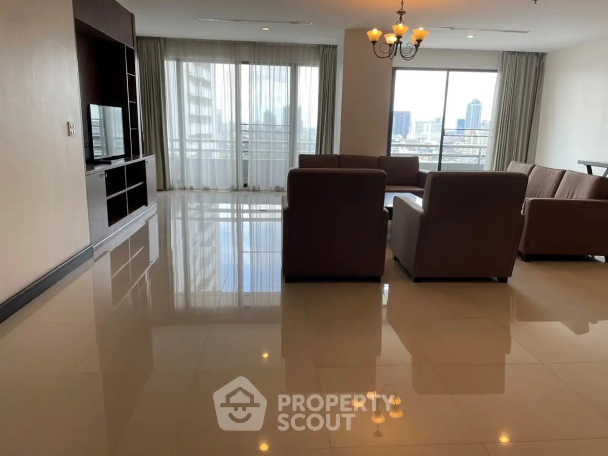 Spacious living room with city view and elegant furnishings in modern apartment.