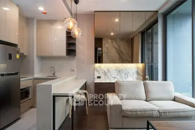 Modern open-plan kitchen and living room with sleek design and natural light.
