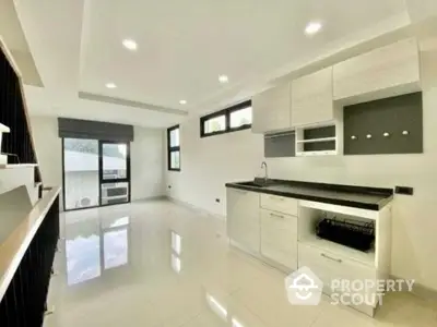 Modern minimalist kitchen with sleek cabinetry and ample natural light