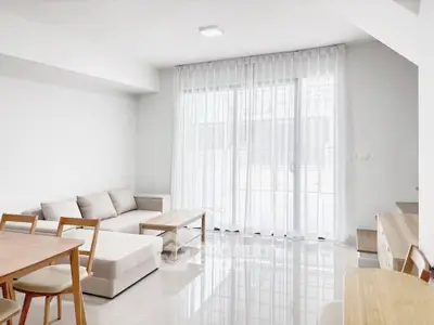 Bright and modern living room with sleek furniture and large windows for natural light.