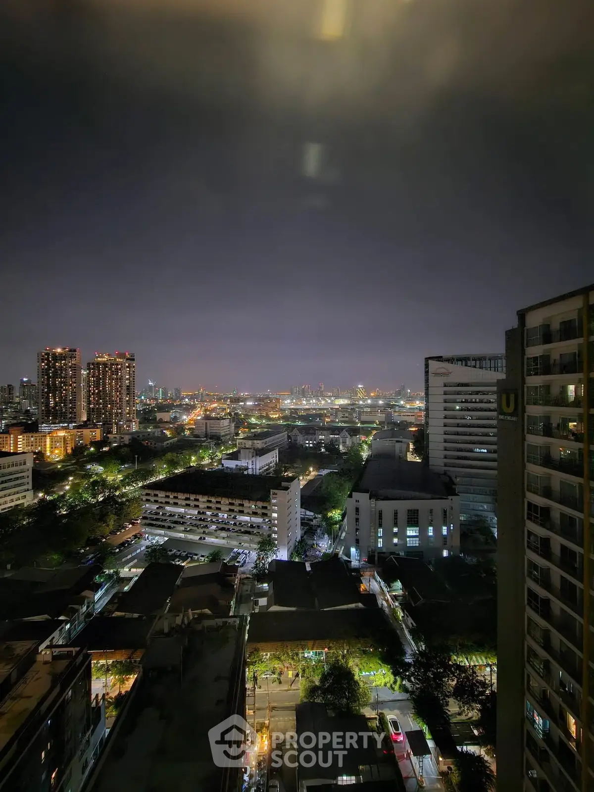 Stunning cityscape view from high-rise building at night with illuminated skyline.