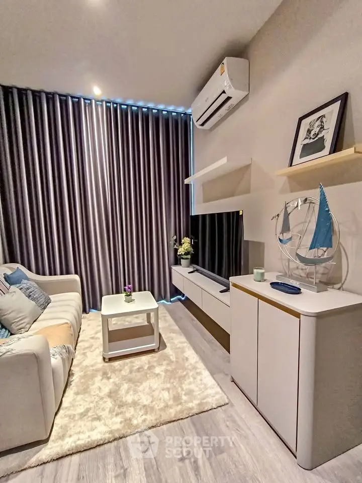 Modern living room with sleek furniture and stylish decor, featuring a cozy sofa and wall-mounted TV.