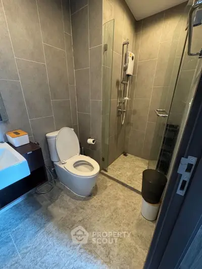 Modern bathroom with sleek shower and stylish fixtures in contemporary apartment.
