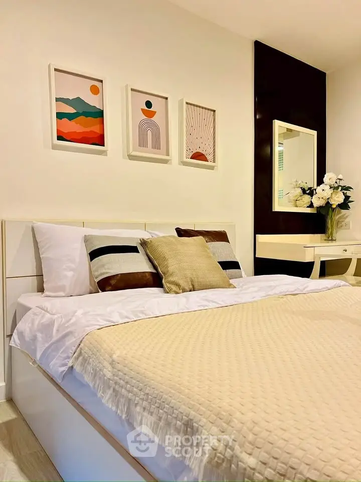 Elegant bedroom with modern decor and cozy bedding in a stylish apartment.