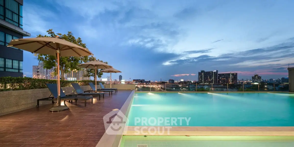 Luxurious rooftop pool with stunning city skyline views at sunset.