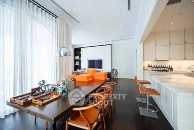 Luxurious modern living room with elegant dining area and sleek kitchen design.