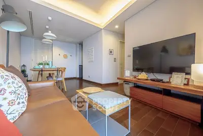 Spacious modern living room with elegant decor and large flat-screen TV