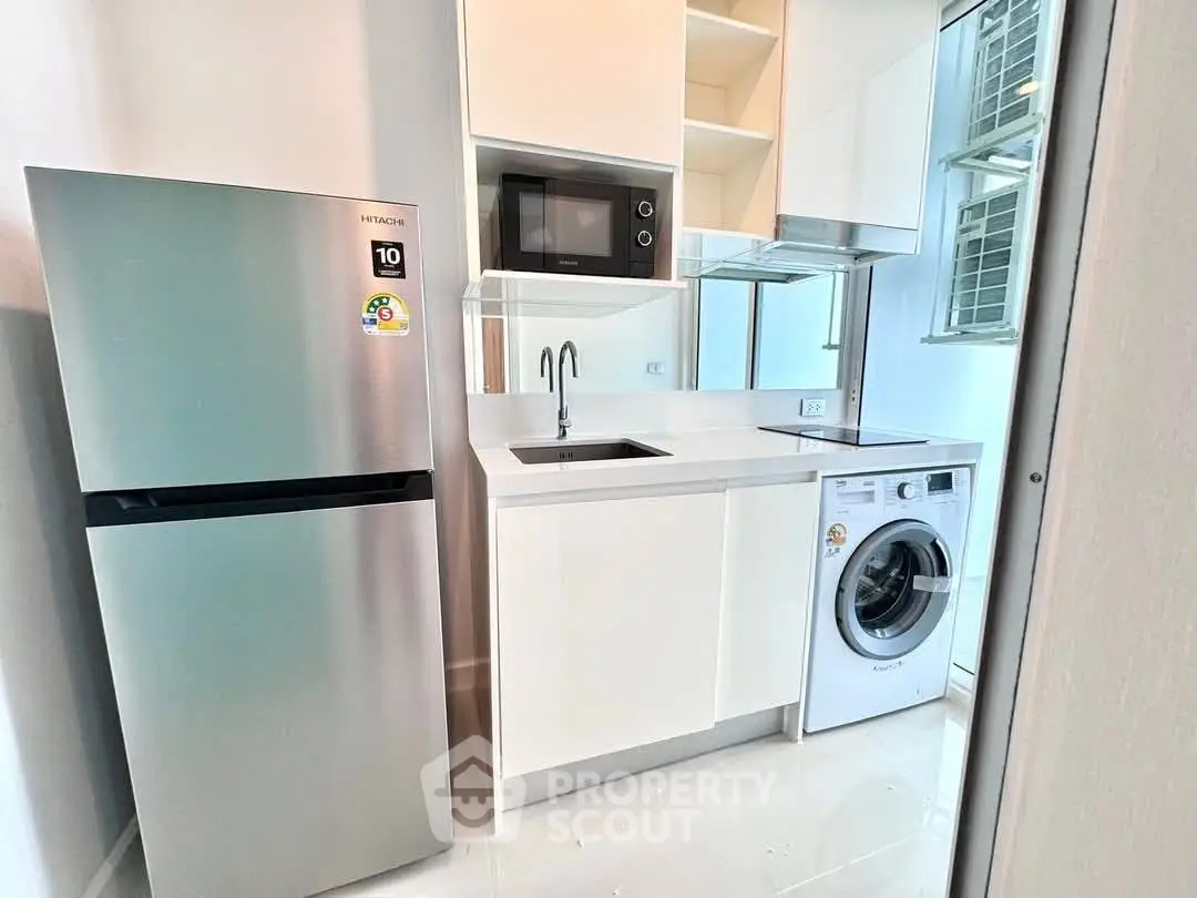 Modern kitchen with sleek appliances and compact design