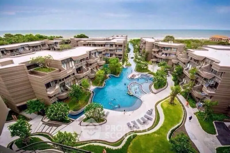 Luxurious beachfront condominium complex with stunning pool and lush gardens.