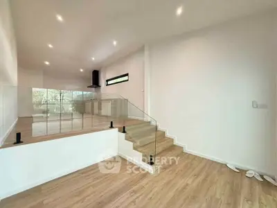 Spacious modern living room with elegant glass railing and open layout