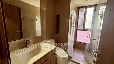 Modern bathroom with sleek fixtures and large window for natural light.