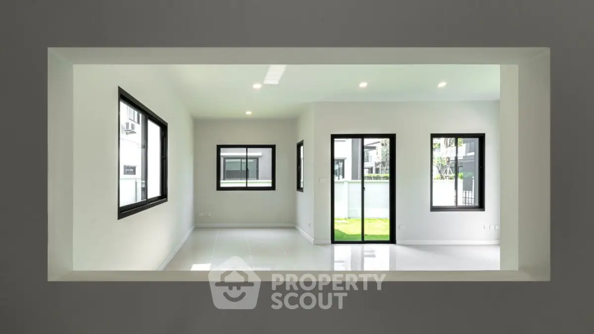 Spacious modern living room with large windows and garden view