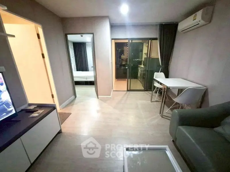 Modern apartment interior with open layout, featuring a cozy living area and dining space.