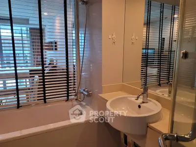 Modern bathroom with bathtub and sleek fixtures in a stylish apartment.