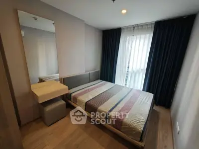Modern bedroom with stylish decor and natural light in a cozy apartment.