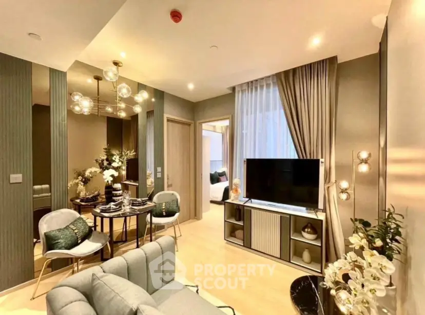Modern living room with elegant decor and open dining area, featuring stylish lighting and cozy ambiance.