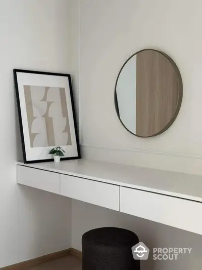 Minimalist study nook with modern decor and round mirror