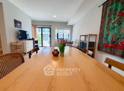 Spacious living room with modern decor and large windows for natural light.