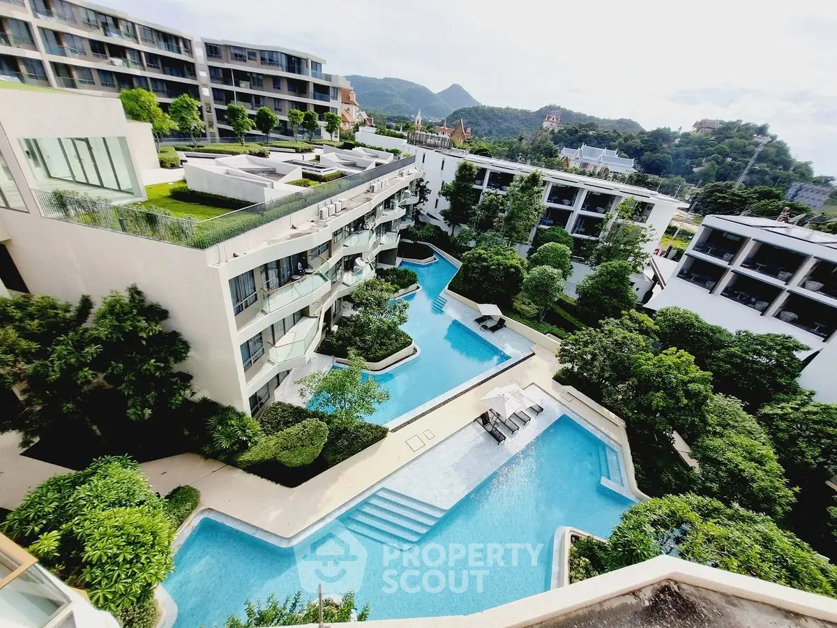 Luxurious residential complex with stunning pool and lush greenery