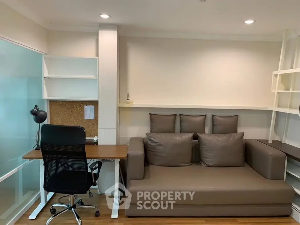 Modern living room with sleek sofa and workspace in stylish apartment