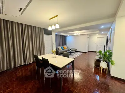 Spacious living room with elegant dining area and modern lighting