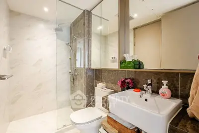 Modern bathroom with glass shower and elegant marble tiles