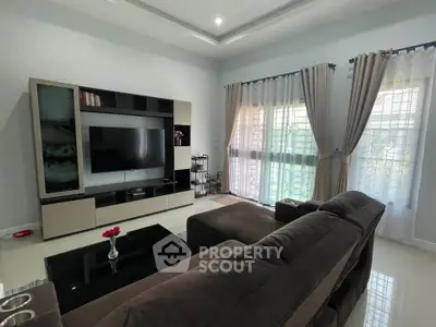 Modern living room with sleek furniture and large windows for natural light.