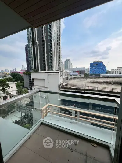 Modern urban balcony with glass railing offering cityscape views