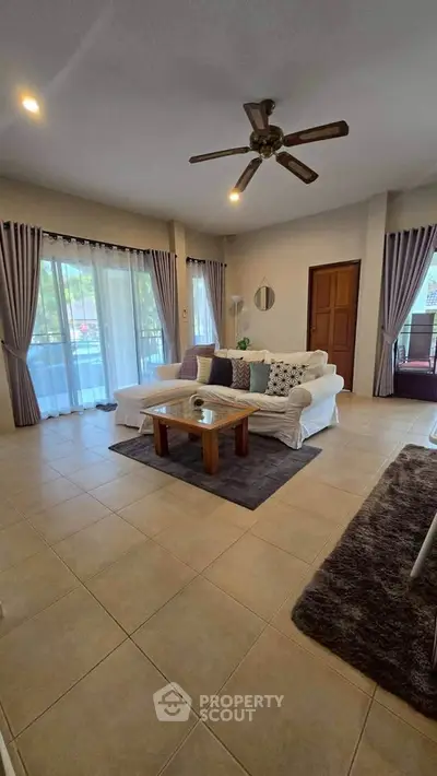 Spacious living room with elegant decor and large windows for natural light.