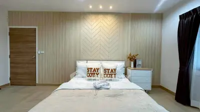 Cozy modern bedroom with stylish decor and natural light