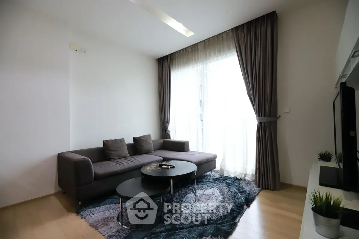 Modern living room with stylish sofa and natural light in a contemporary apartment.