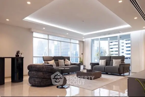 Spacious modern living room with city view and elegant furnishings.