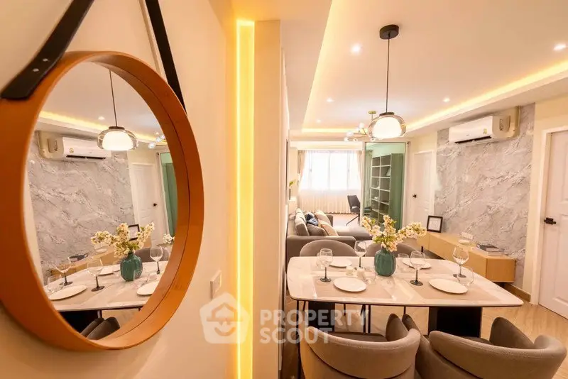 Stylish modern living room with elegant dining area and decorative mirror