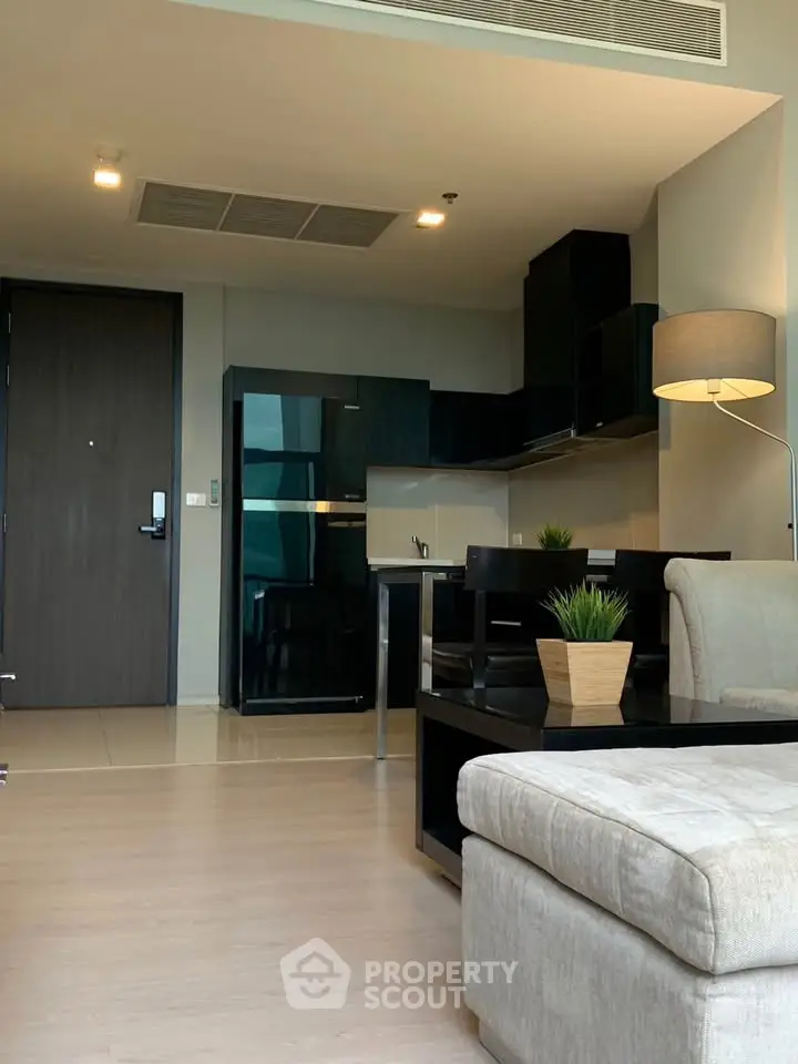 Modern open-plan living room with sleek kitchen and stylish decor