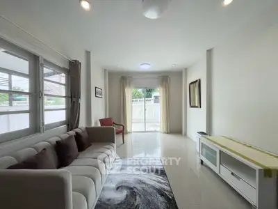 Spacious living room with modern decor and large windows for natural light
