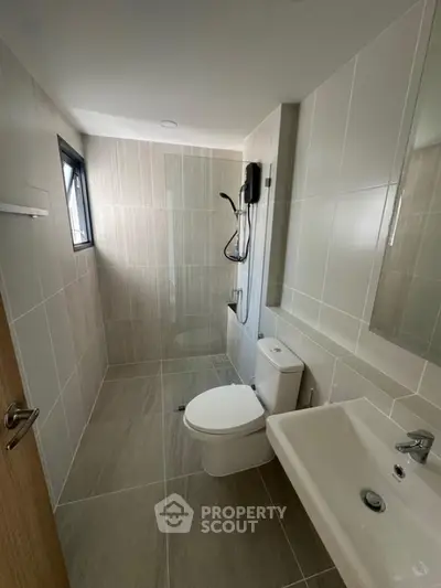 Modern bathroom with sleek design and neutral tiles