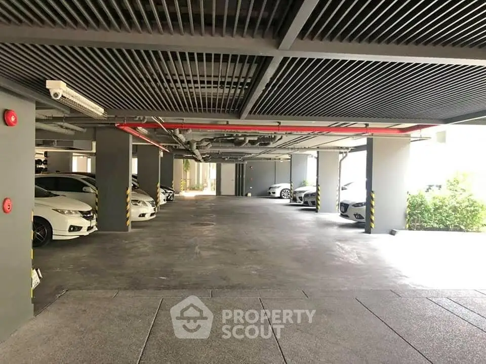 Spacious underground parking area with multiple parked cars and modern design.