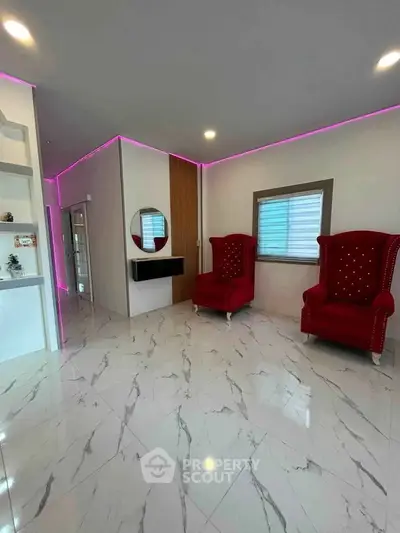 Modern living room with marble flooring and stylish red armchairs