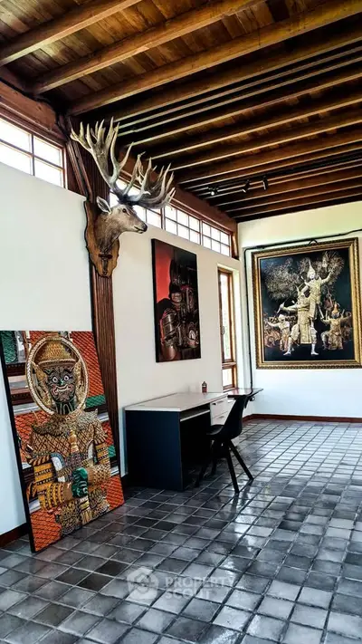 Chic study room with artistic decor and wooden ceiling beams