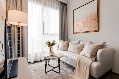 Modern living room with elegant decor, cozy sofa, and large window for natural light.