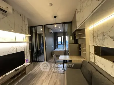 Modern living room with marble accents and cozy bedroom view