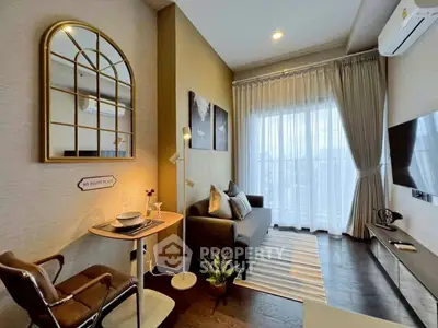 Cozy living room with modern decor and large window, perfect for relaxation.