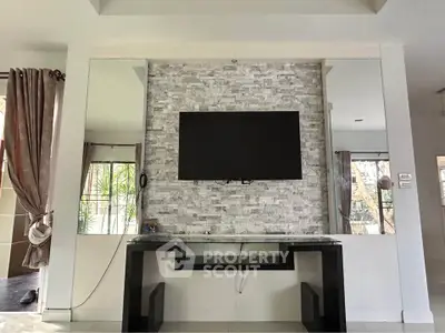 Modern living room with wall-mounted TV and stylish stone accent wall