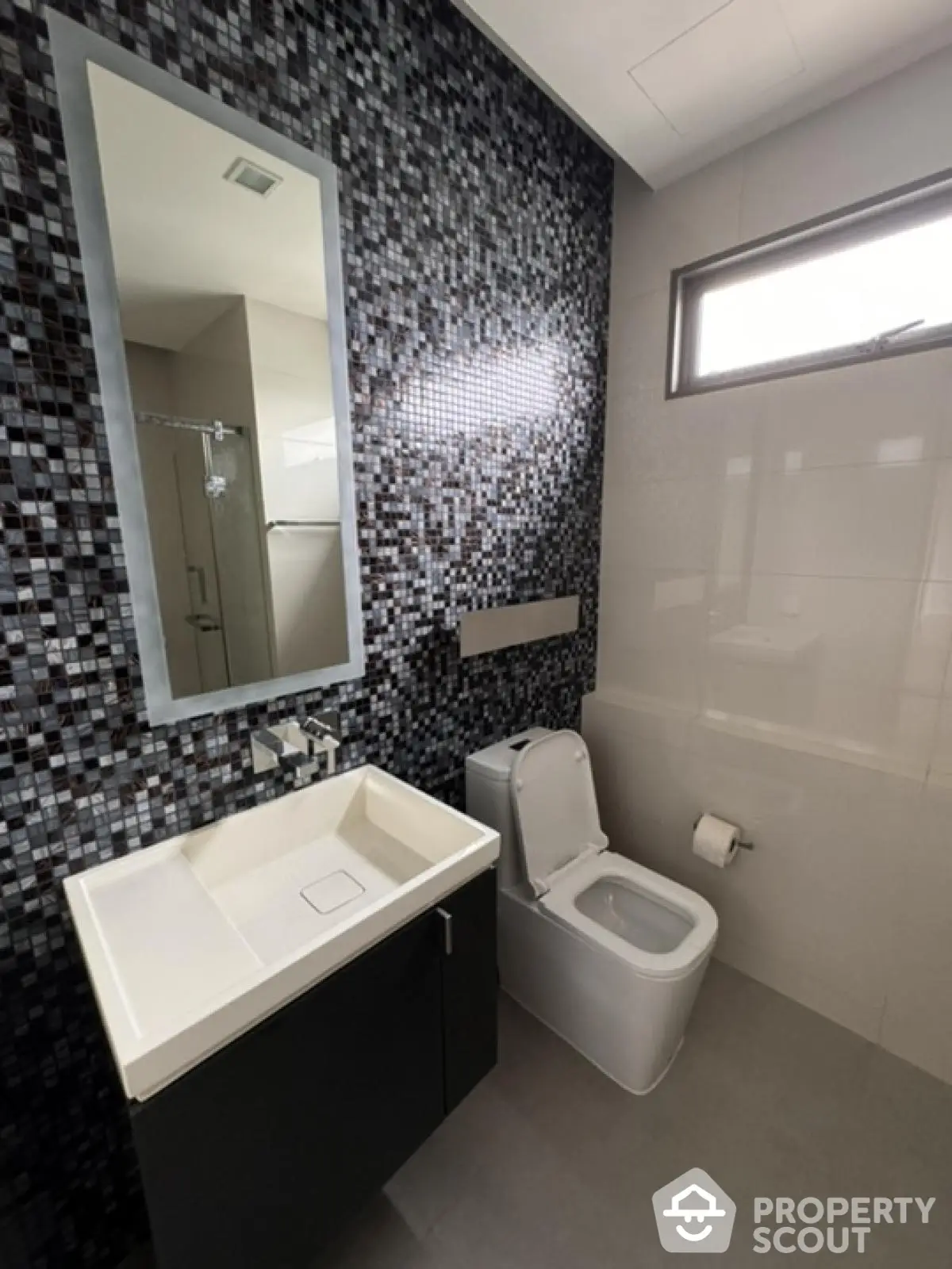 Modern bathroom with sleek design and mosaic tile wall