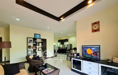 Spacious modern living room with stylish decor and open layout to kitchen area.
